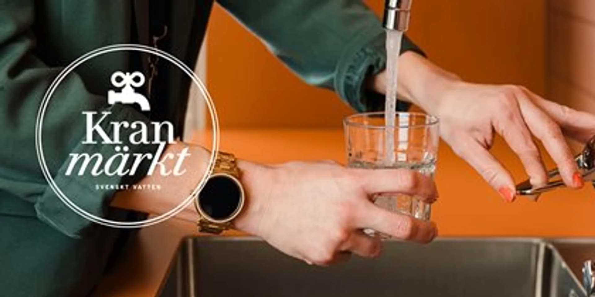 En kvinna fyller ett glas vatten från en kran.